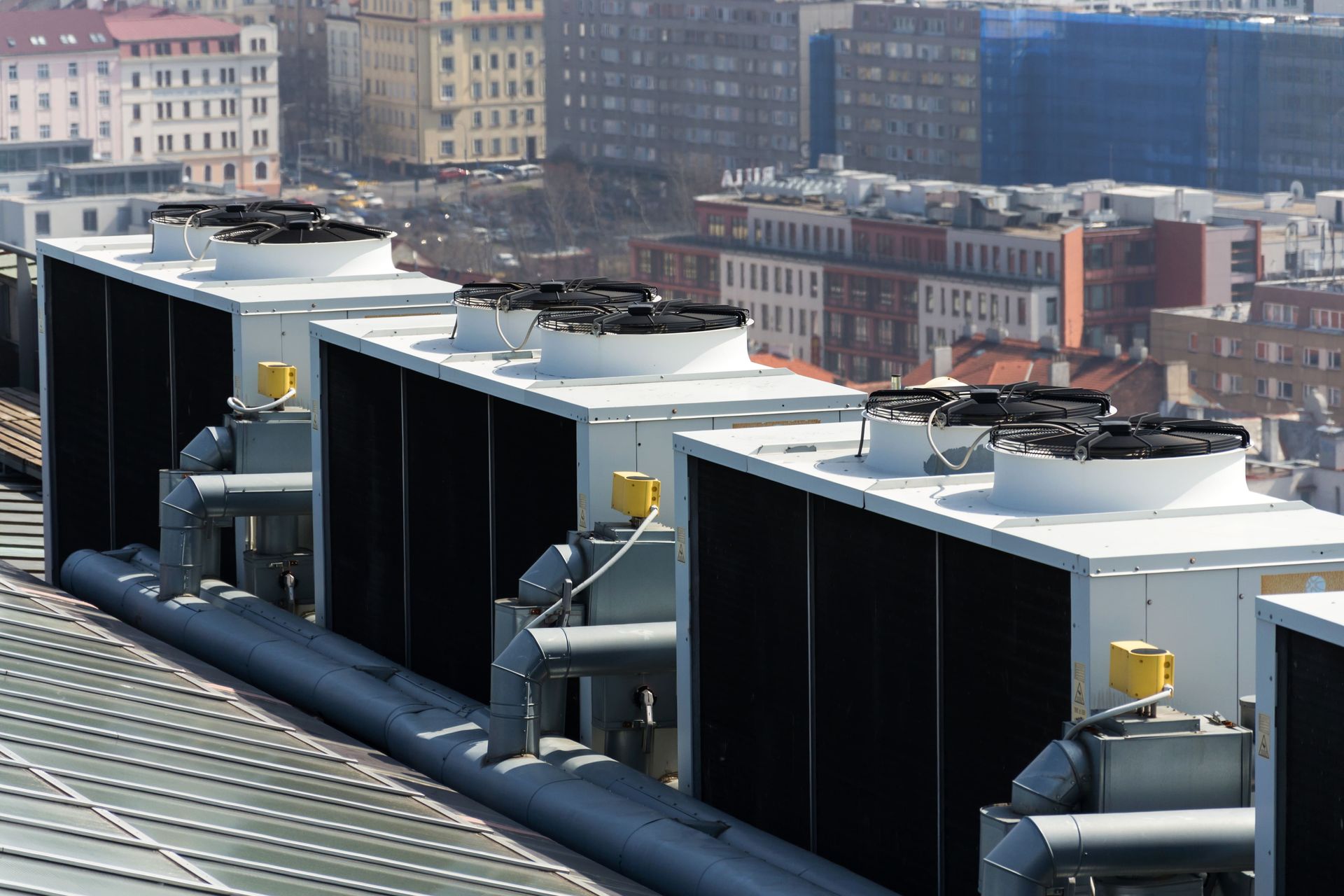 A row of cooling towers on the roof of a building