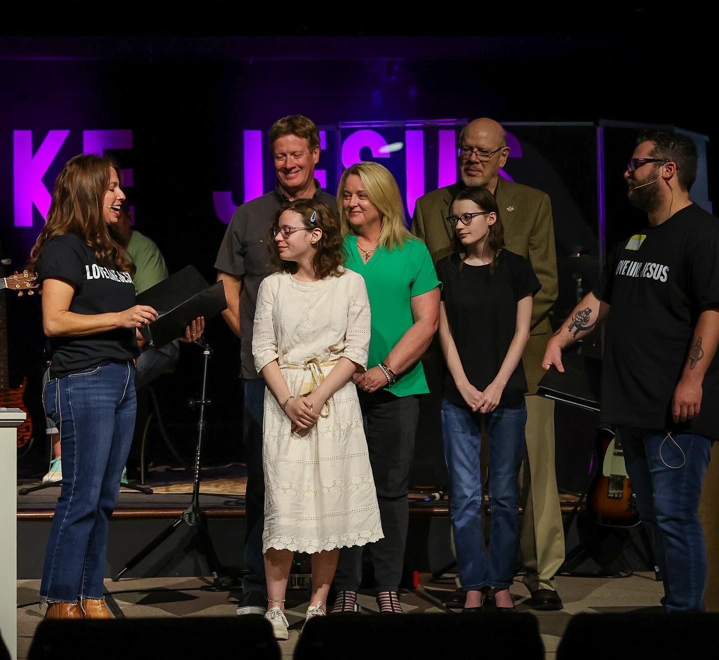 Pastors engaging with a baptism candidate and family