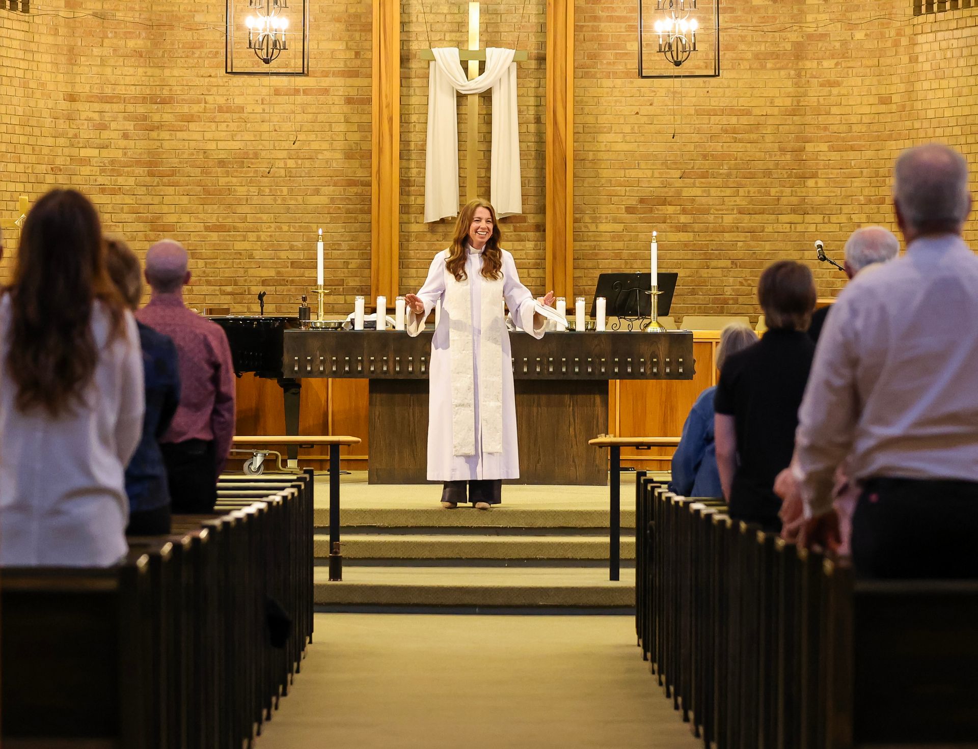 Worship leader in a suit playing organ.
