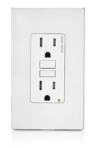 A white electrical outlet with a green light on it on a white background.