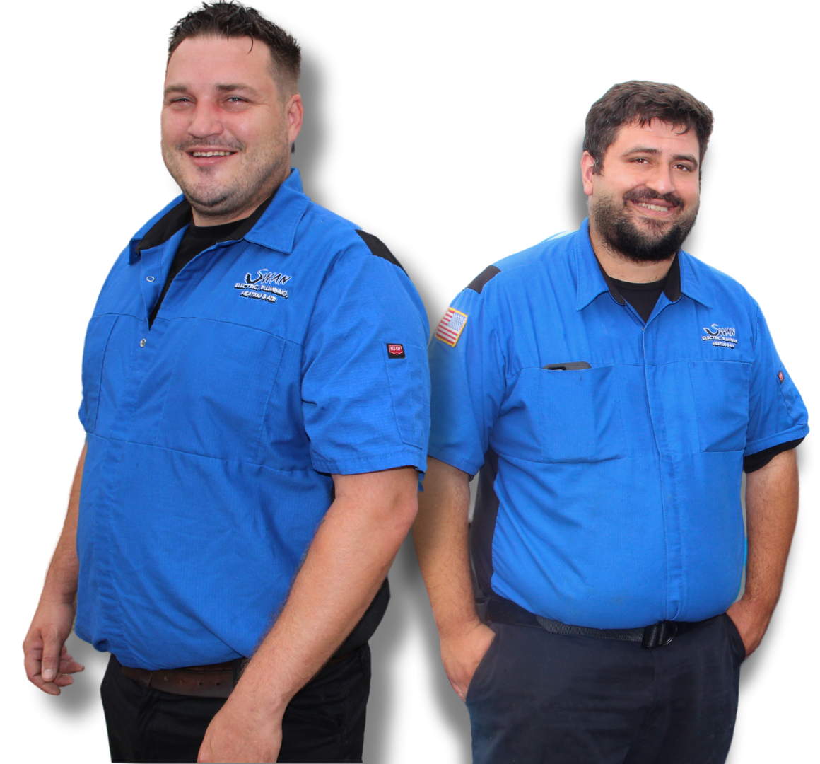 Two men in blue shirts are standing next to each other