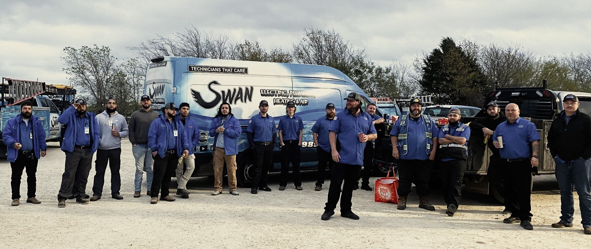 Swan electric plumbing heating and air team standing out side of their shop