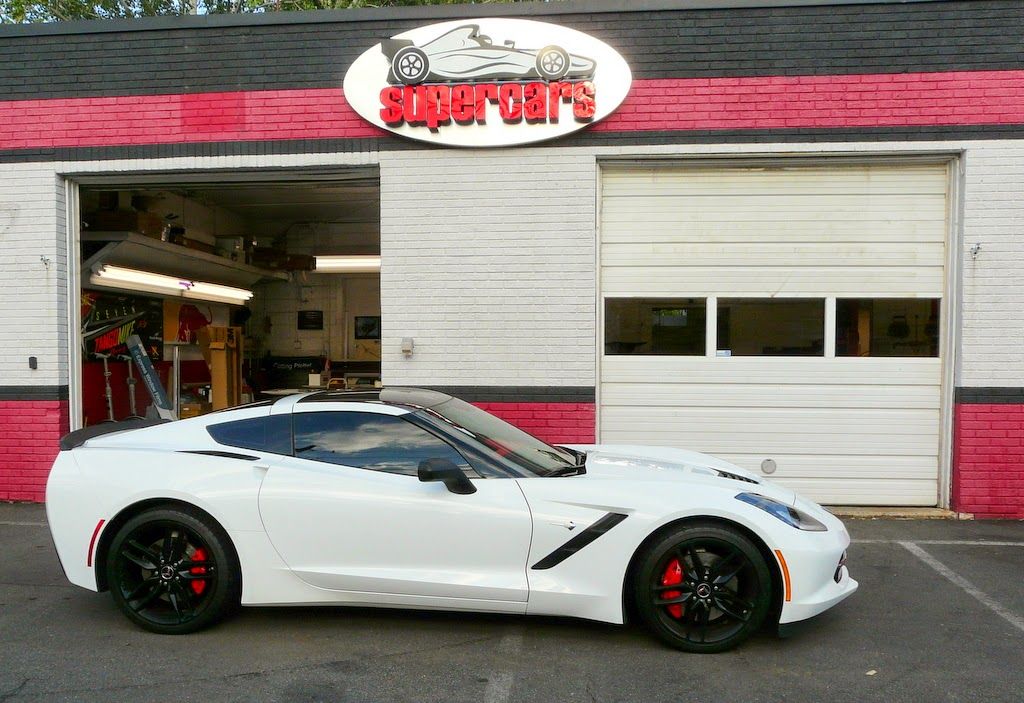 White sports car parked outside a 