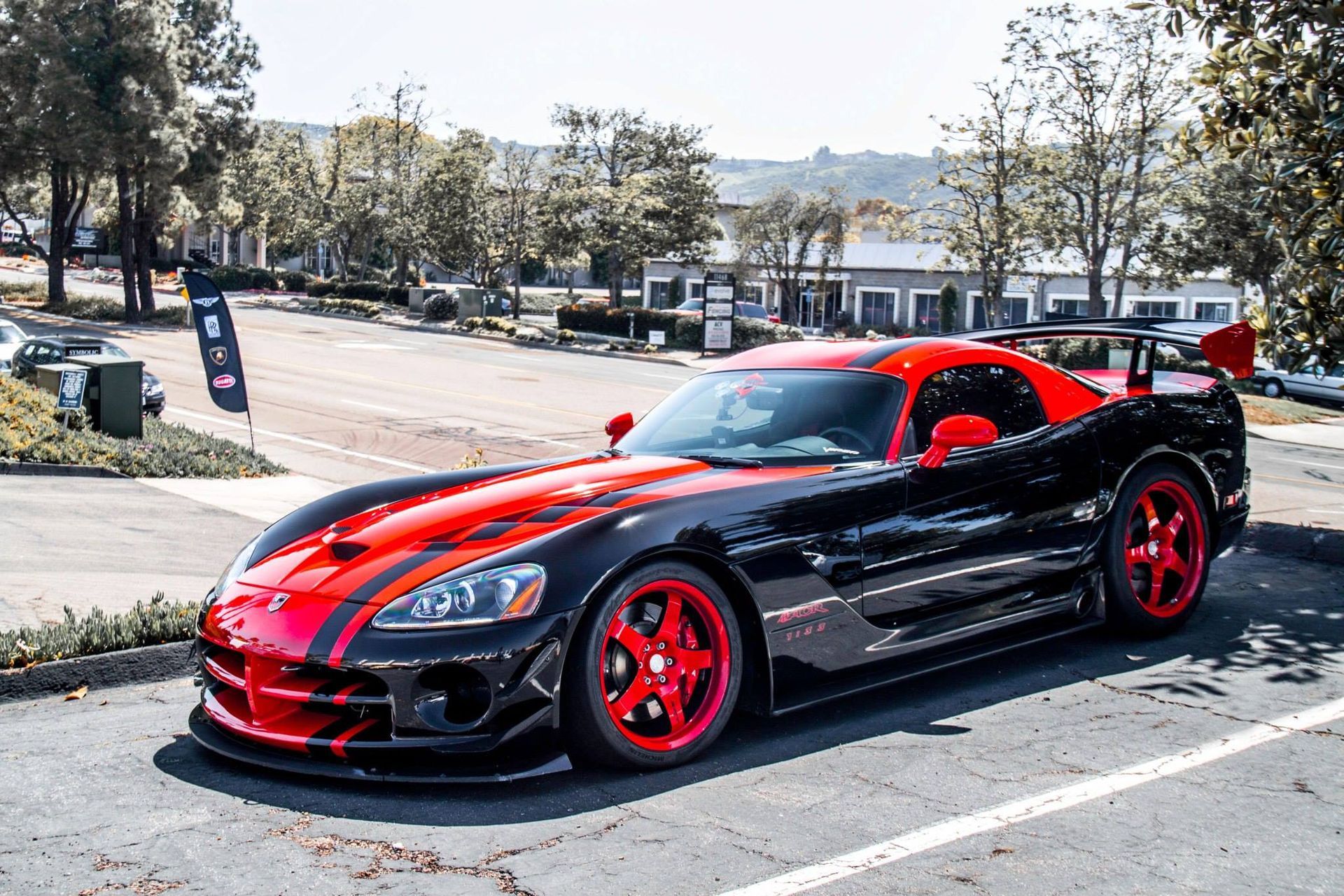 Black and red Dodge Viper sports car parked outdoors.