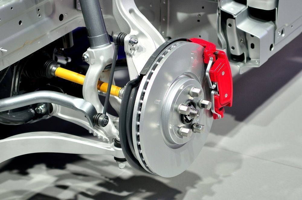 Car suspension and red brake caliper.