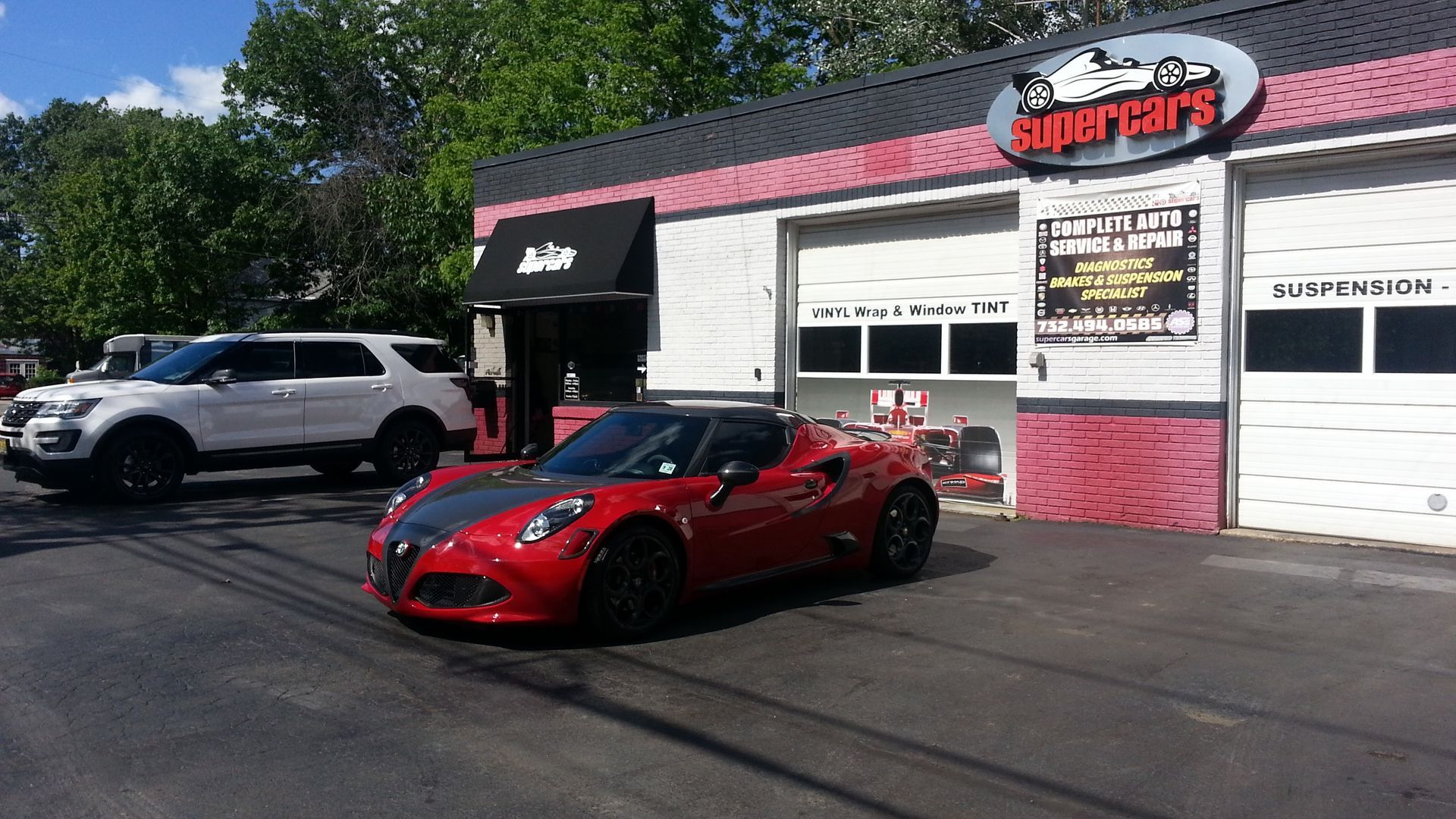 Red sports car parked in front of a 