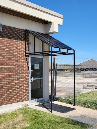A brick building with a canopy over the door.