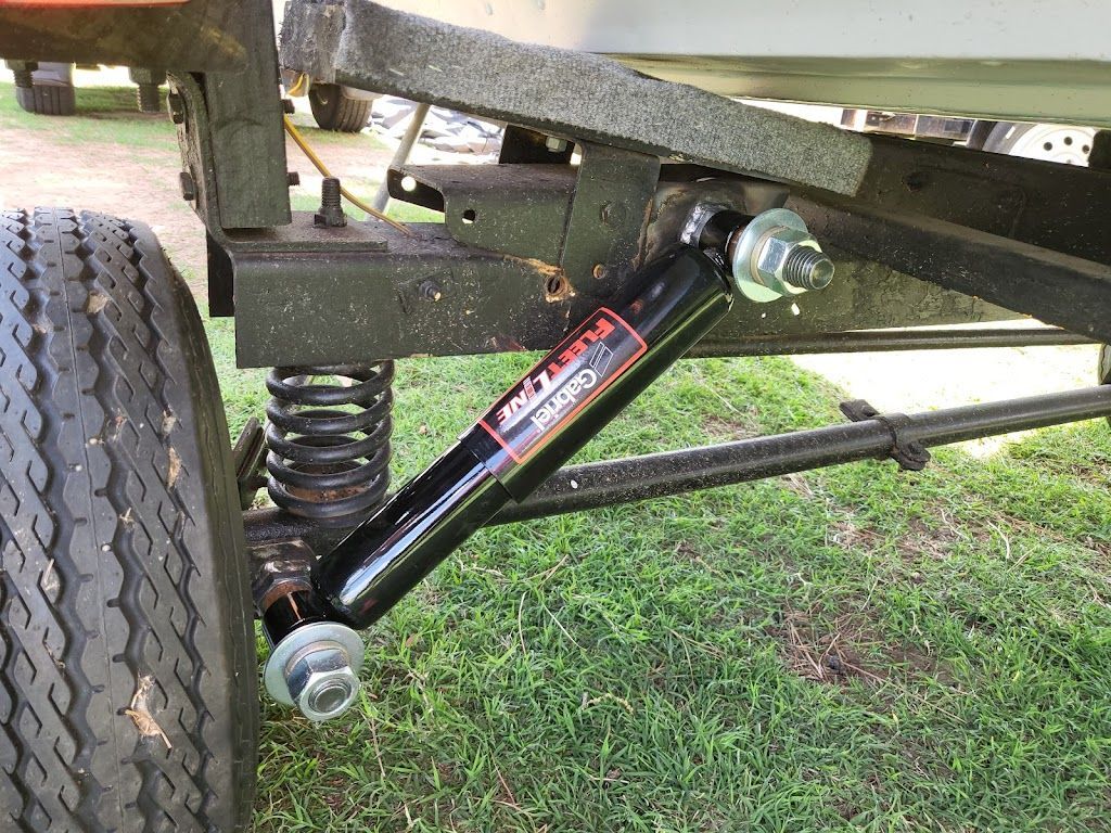 A close up of a suspension system on a trailer.