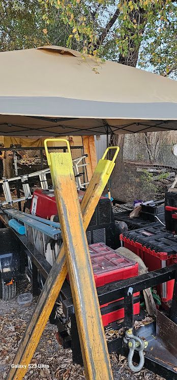 A bunch of tools are sitting under a tent.