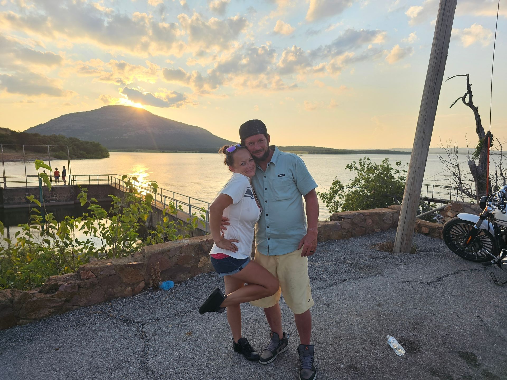 A dog is standing in front of a building with the door open.