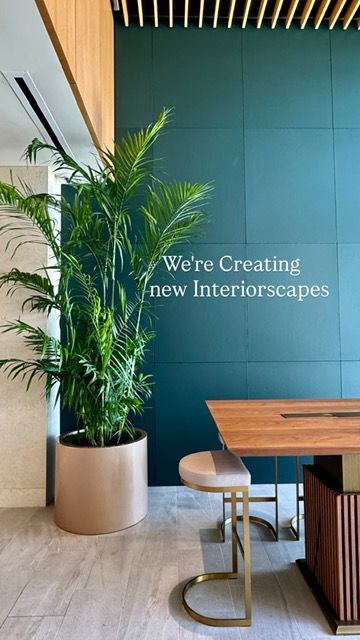 A room with a table and chairs and a sign that says `` we 're creating new interiorscapes ''