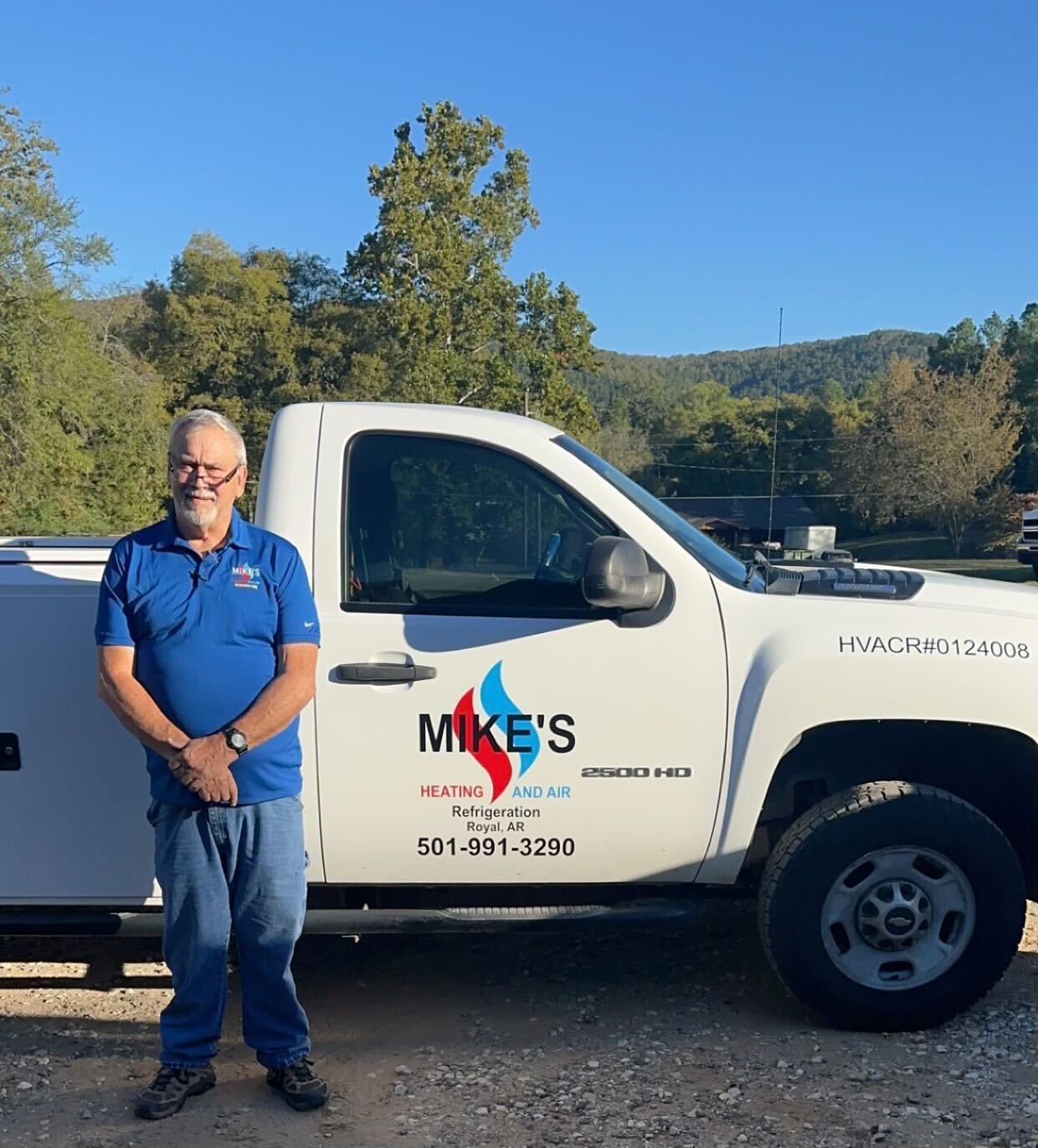 A man standing in front of a mike 's truck