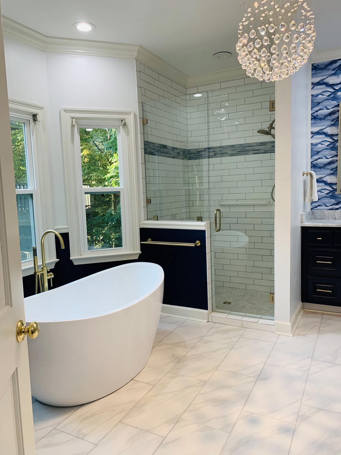 A bathroom with a bathtub and a walk in shower