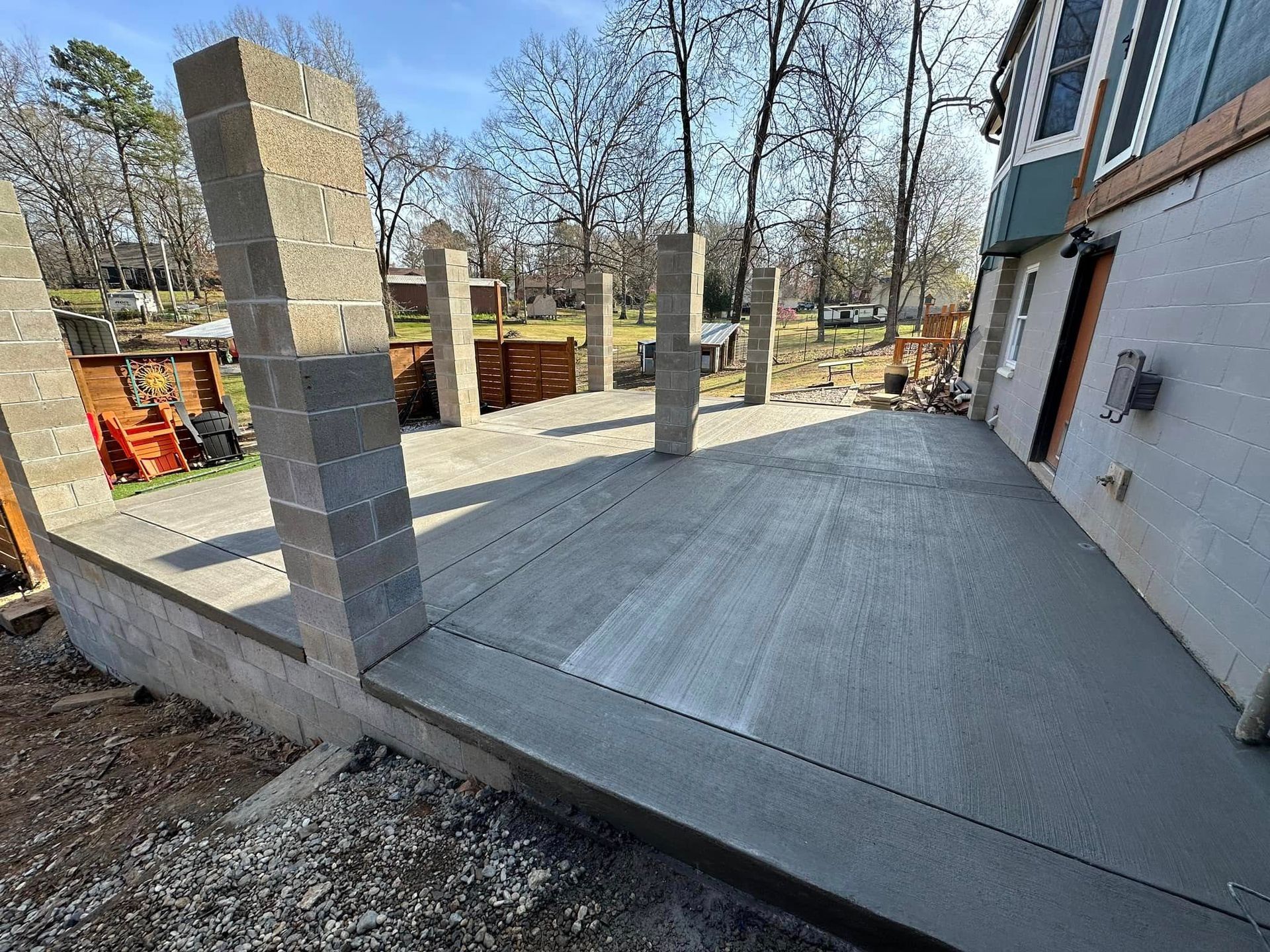 A concrete deck is being built in front of a house.