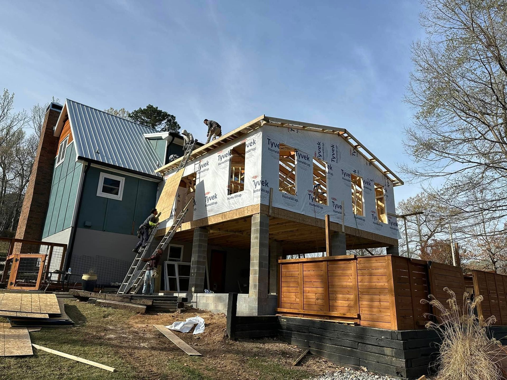 A house is being built in the middle of a field.
