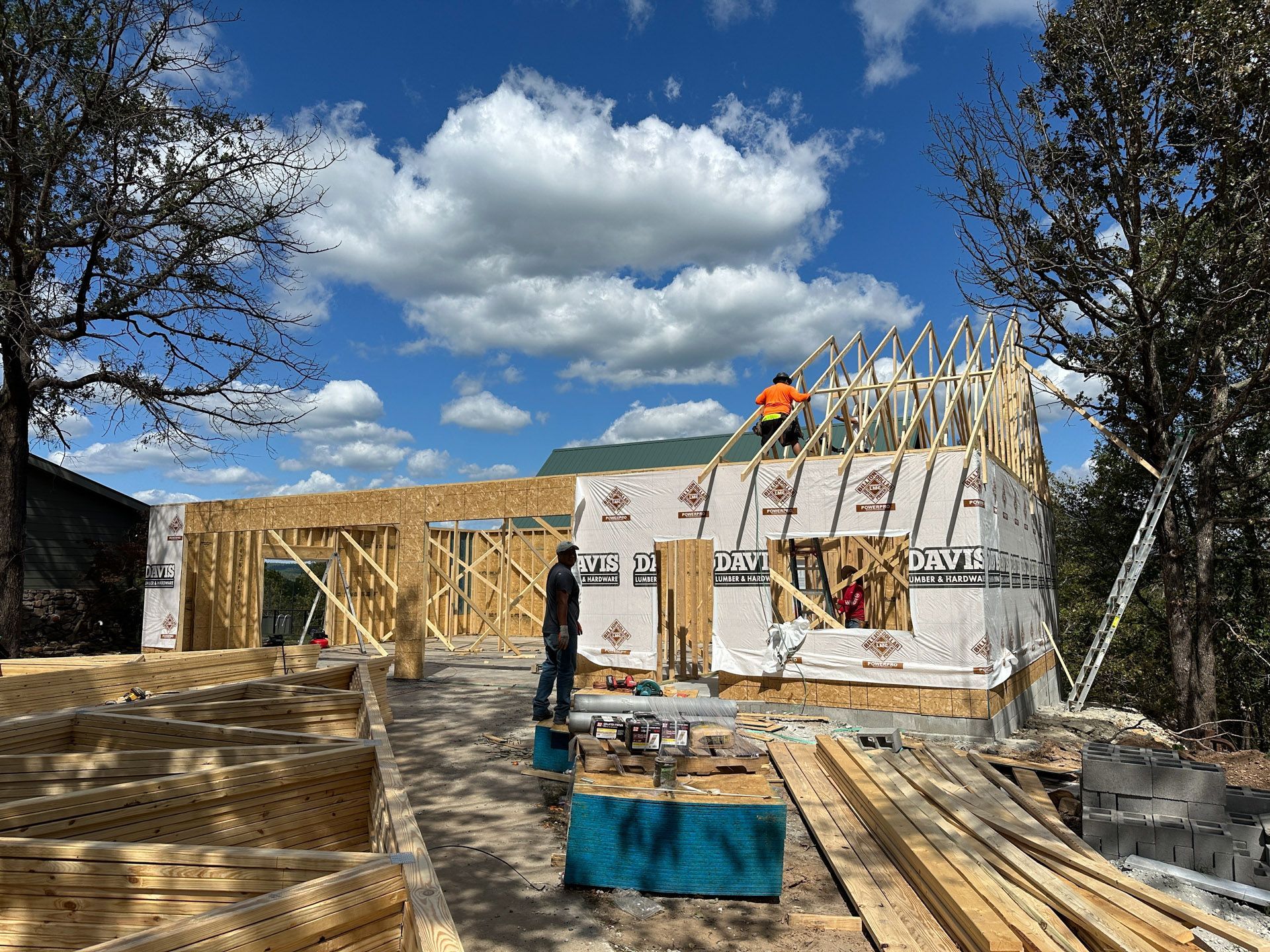 A house is being built on a hill with a lot of wood.