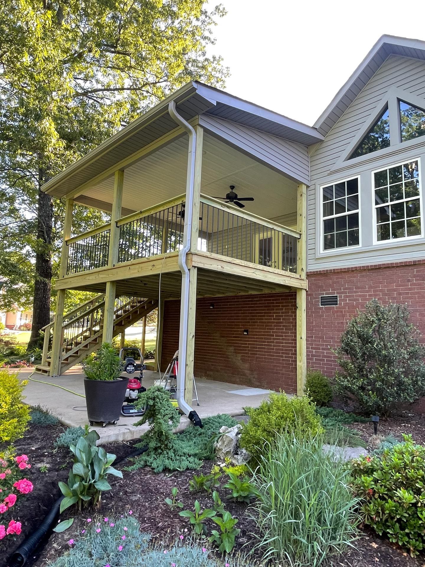 A house with a large porch and a ceiling fan.