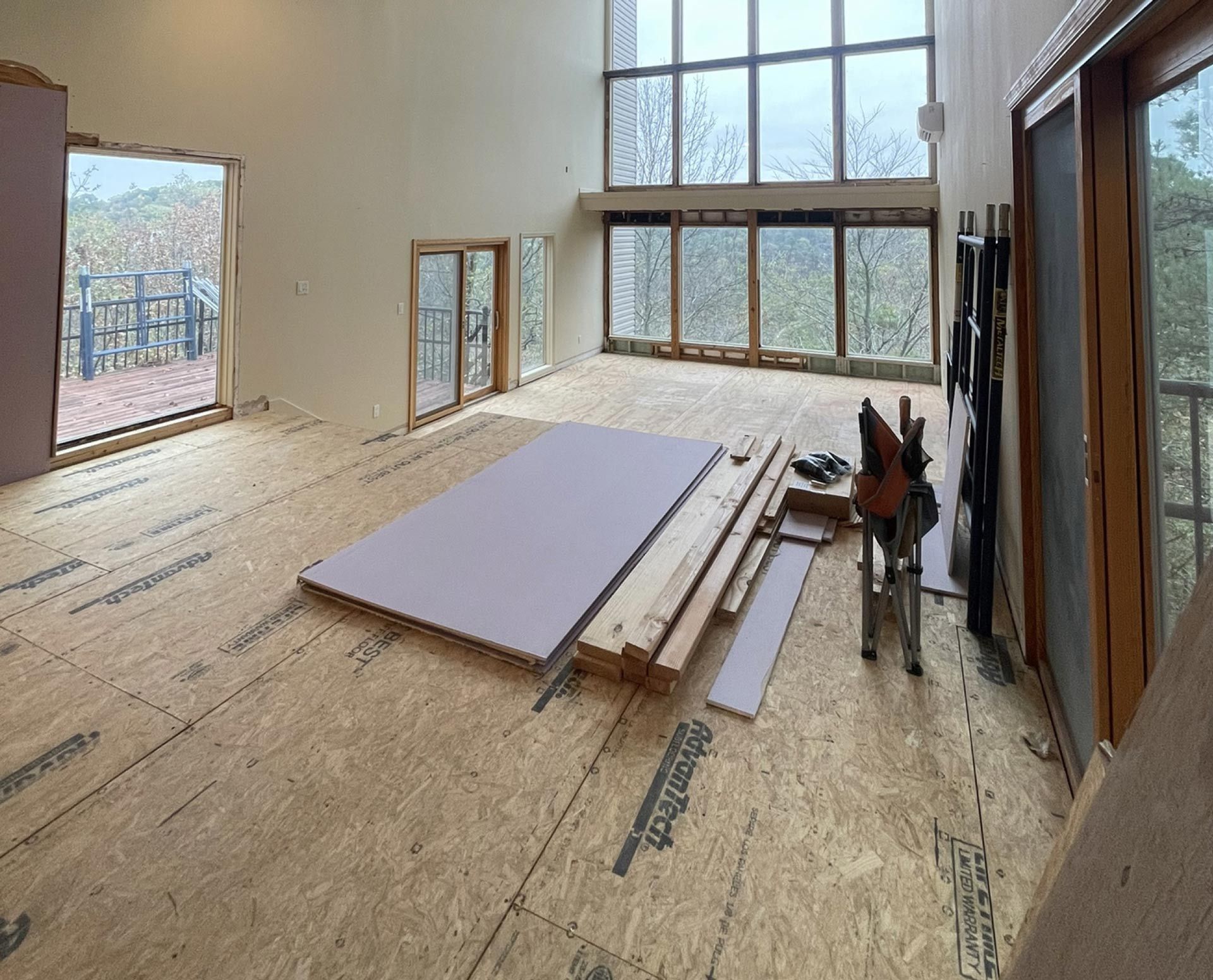A large room with a lot of windows and a wooden floor