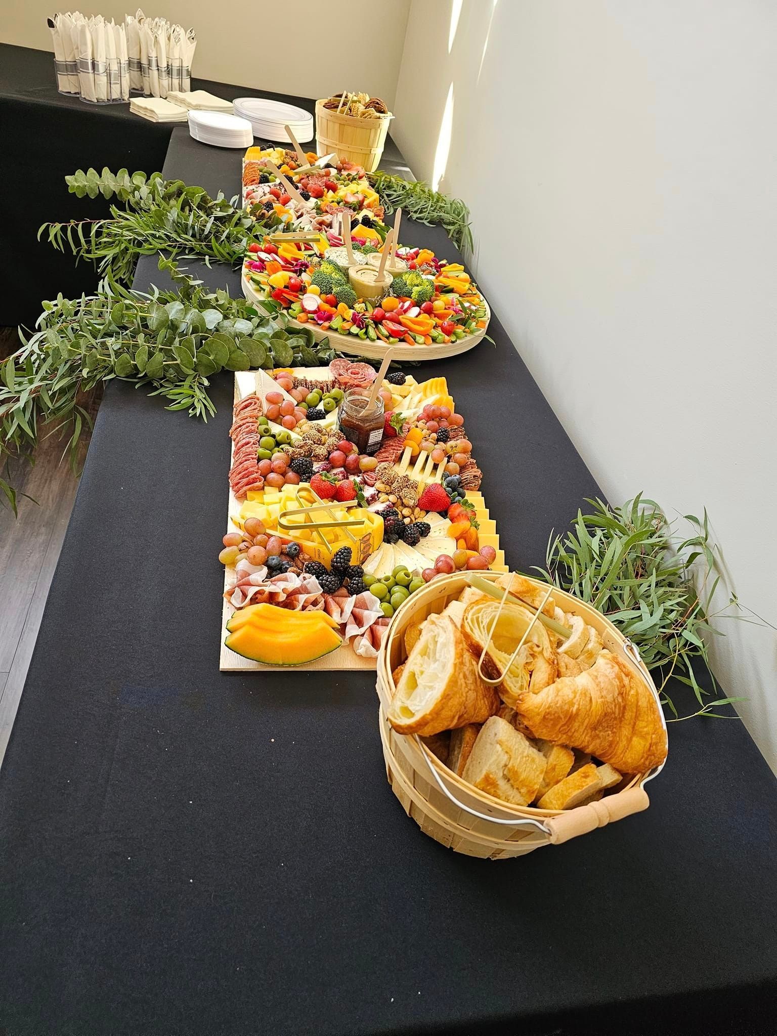 A buffet table with a basket of bread on it.