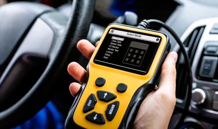 Hand holding diagnostic tool during car diagnostic test