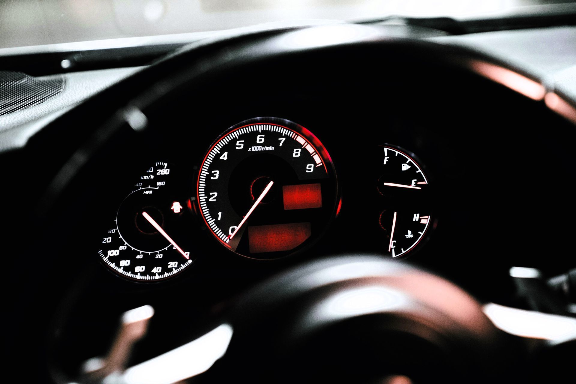 Close-up view of a car's dashboard with illuminated warning lights