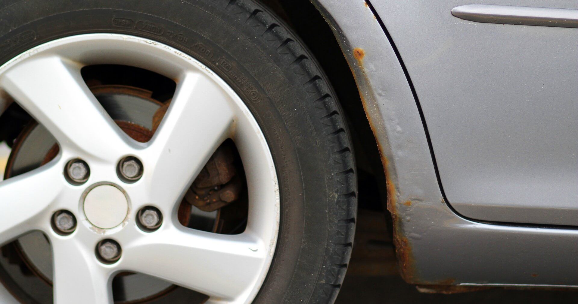 Telltale signs of rust showing through underneath the paint of the car