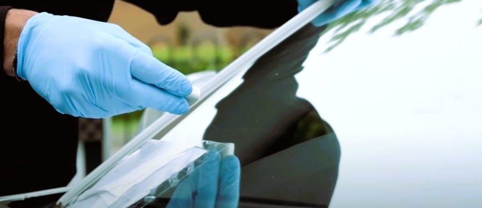 Skilled professional repairing windshields through expert repair and replacement services.