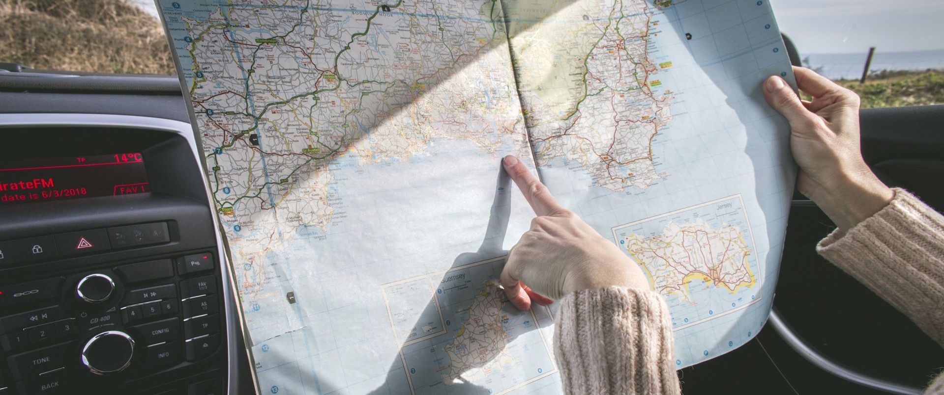 pointing at a map during a road trip