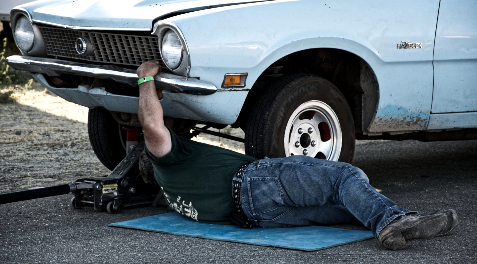 mobile mechanic working on old car