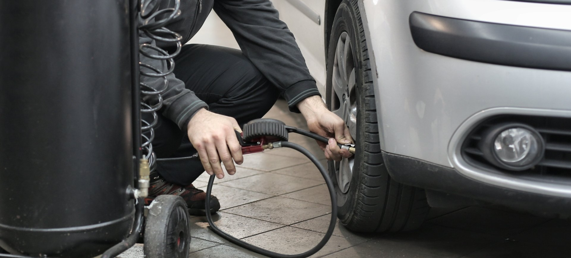 a man adding air to low tires