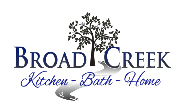 Logo for Broad Creek Kitchen-Bath-Home, featuring a tree and stream, with blue and white text.