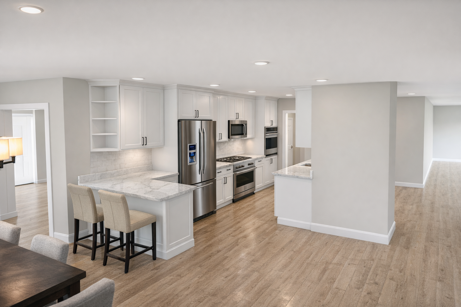 Modern kitchen with white cabinets, stainless steel appliances, and a breakfast bar.