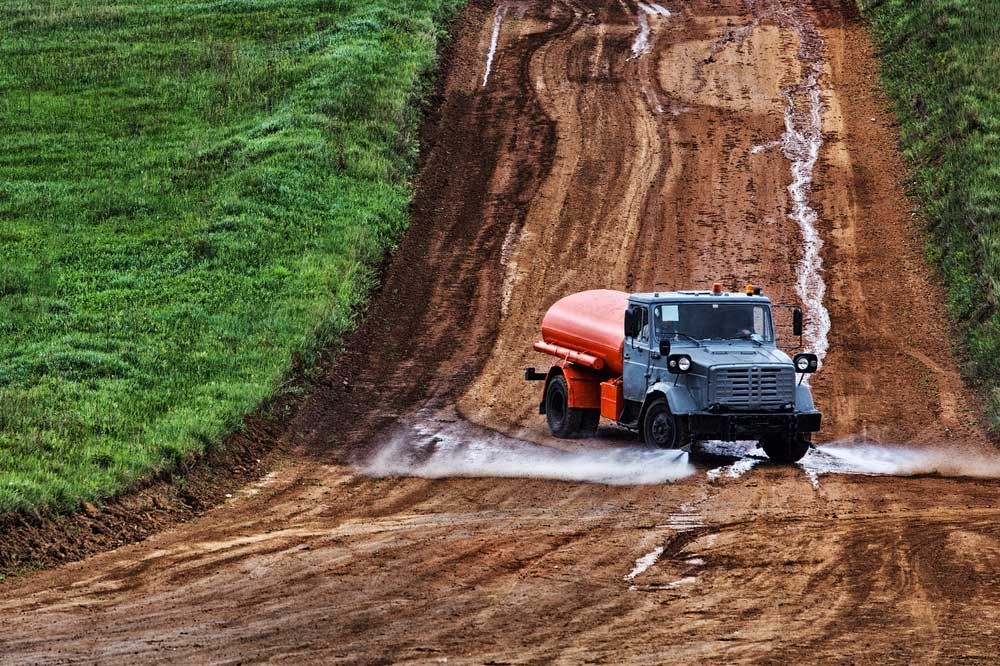 A Truck is Driving Down a Dirt Road — Nabiac Water Carriers in Forster, NSW