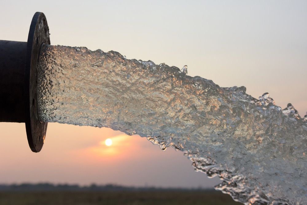 A Close Up of Water Coming Out of a Pipe at Sunset — Nabiac Water Carriers in Old Bar, NSW