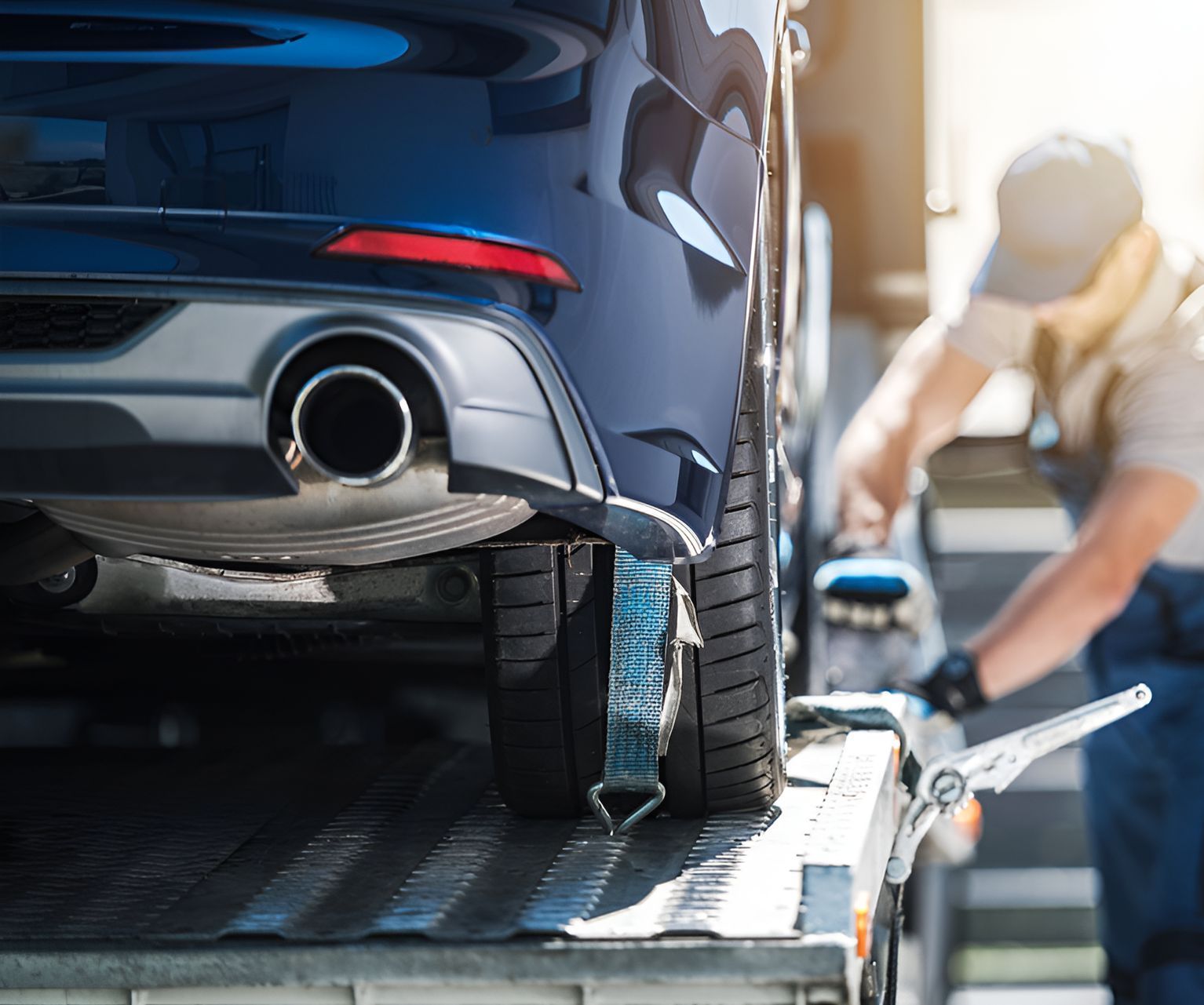 A Man Is Towing A Car On A Tow Truck — Torquay & Anglesea Accident Towing Centre In Torquay, VIC