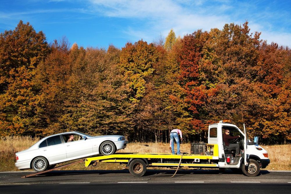 A Tow Truck Is Towing A Car On The Side Of The Road — Torquay & Anglesea Accident Towing Centre In Colac, VIC