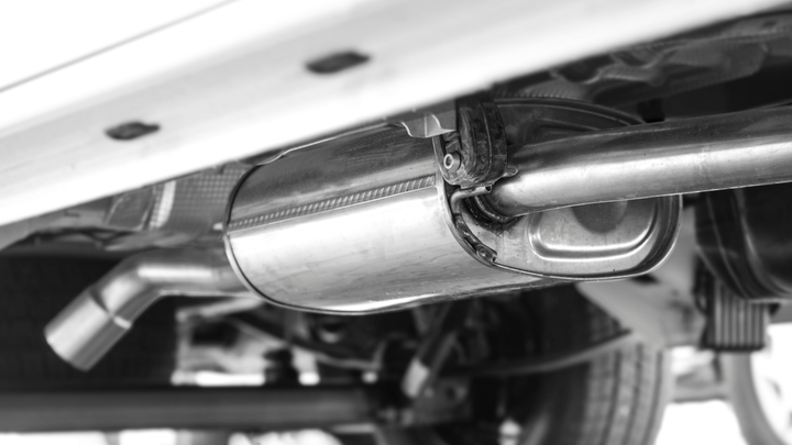 A black and white photo of a car exhaust pipe.