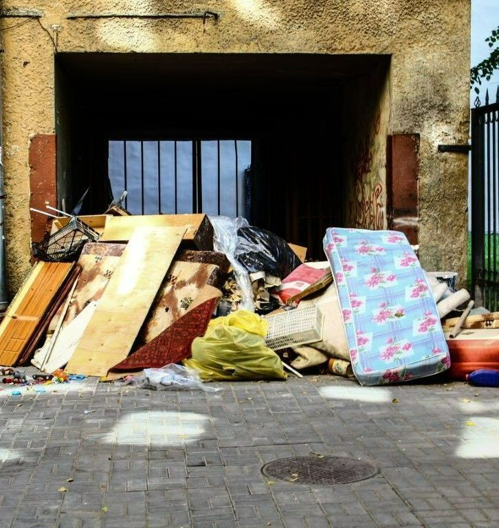 piles of junk on side of street