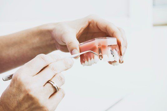 Patients in need of replacing missing or damaged teeth have several options, including a combination