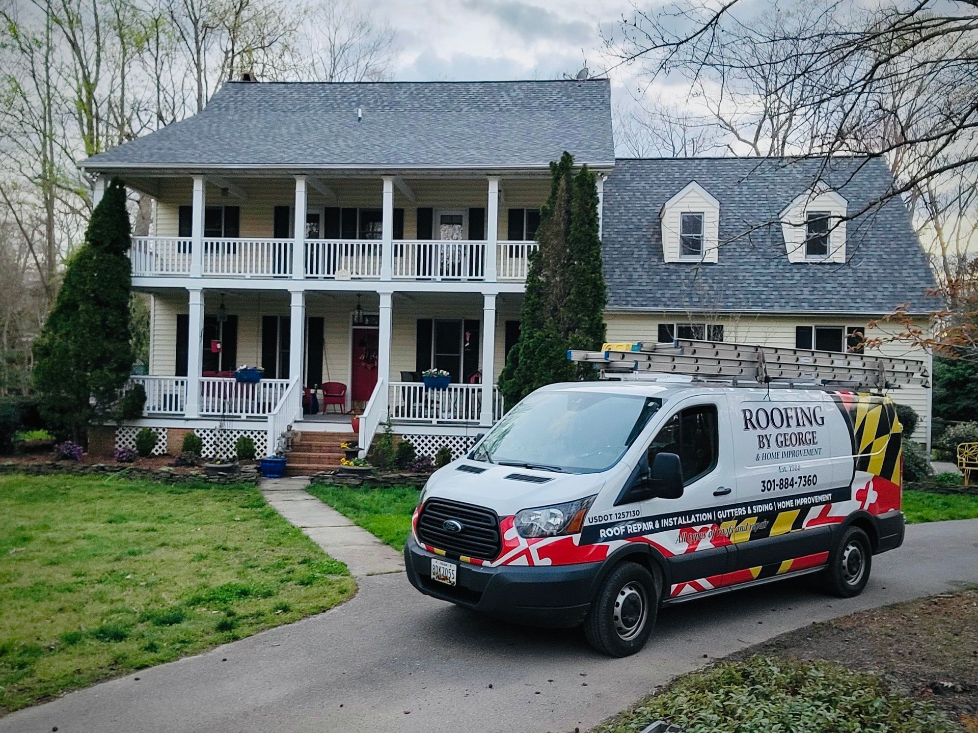 A white van is parked in front of a large house.