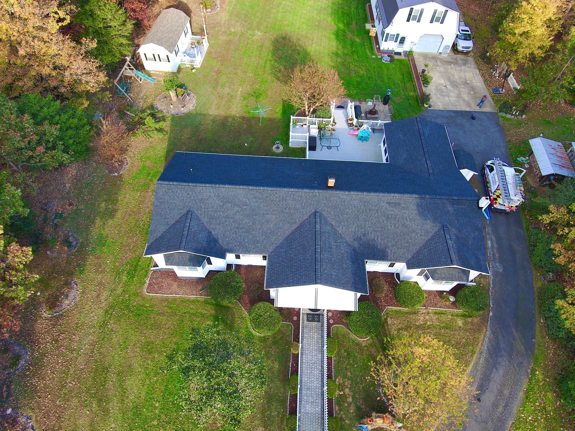 An aerial view of a house with a black roof