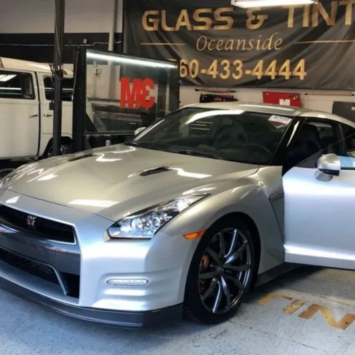 Silver Nissan GT-R with door open in a glass and tint shop in Oceanside, CA.