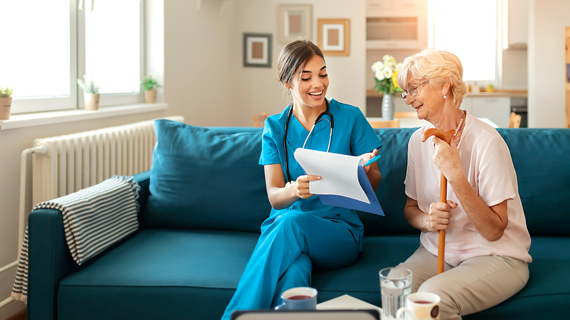 caregiver going over information on clipboard with elderly patient