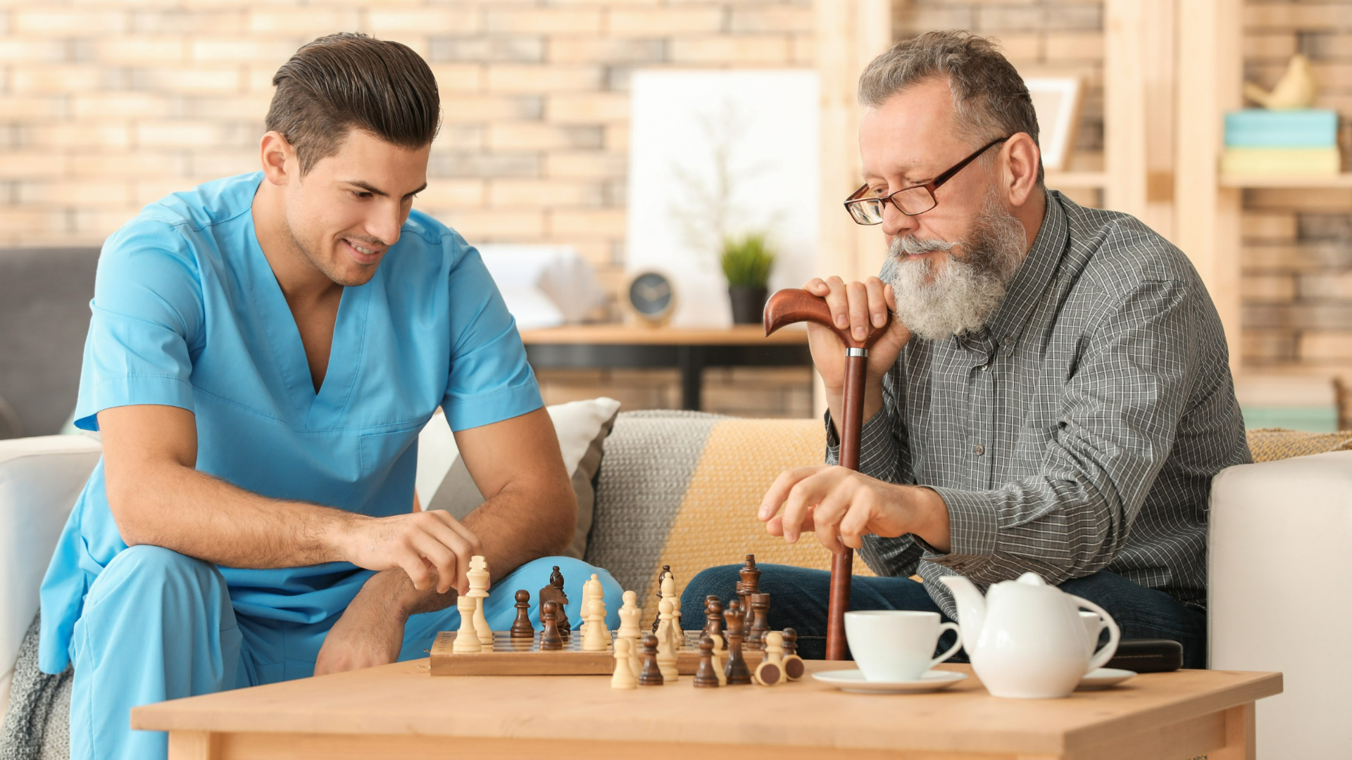 caregiver playing chess with elderly client