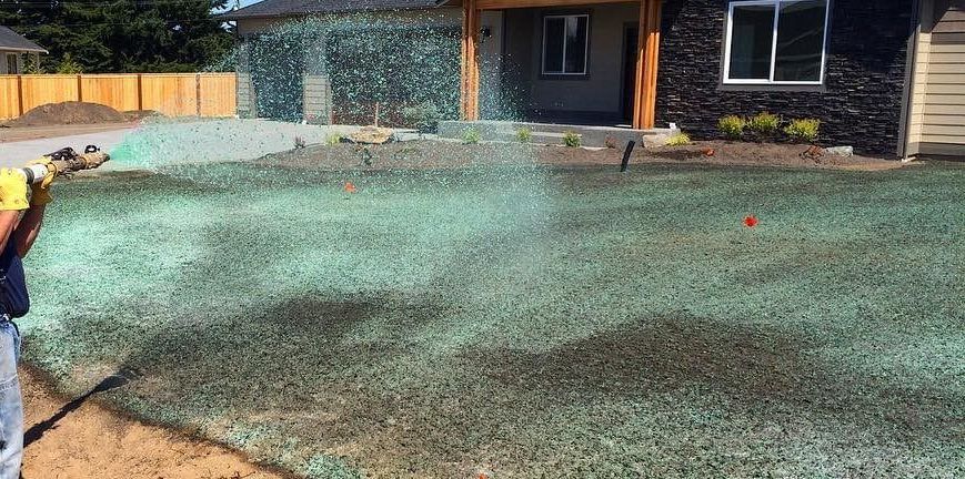 A large house with a lot of windows and a garage on a rainy day.
