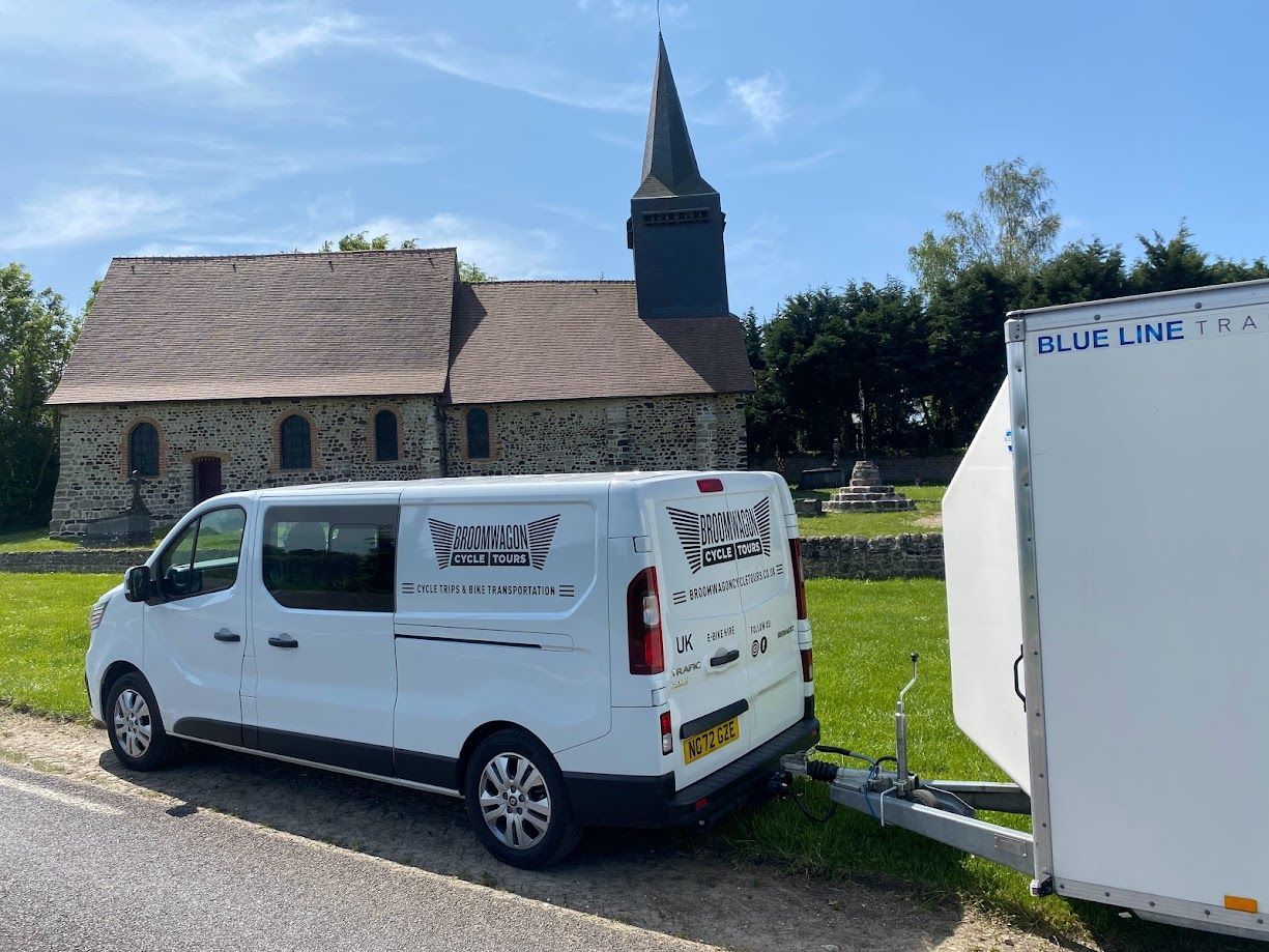 White van with black wheels parked outdoors, labeled “FULY SUPERB WHEELS” on the side.