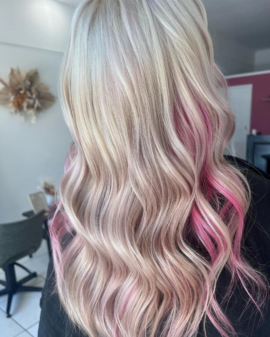 A Woman with Blonde and Pink Hair Is Sitting in A Chair — Losh Hair Lounge In Toowoomba City, QLD