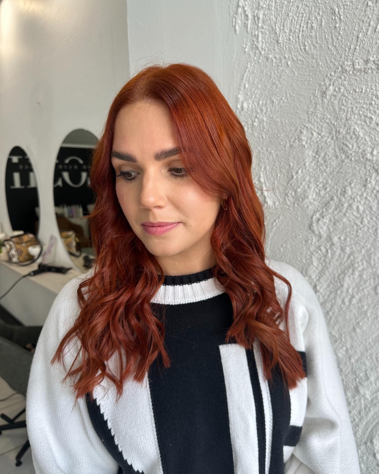 A Woman with Pink Hair Is Sitting in A Chair — Losh Hair Lounge In Toowoomba City, QLD