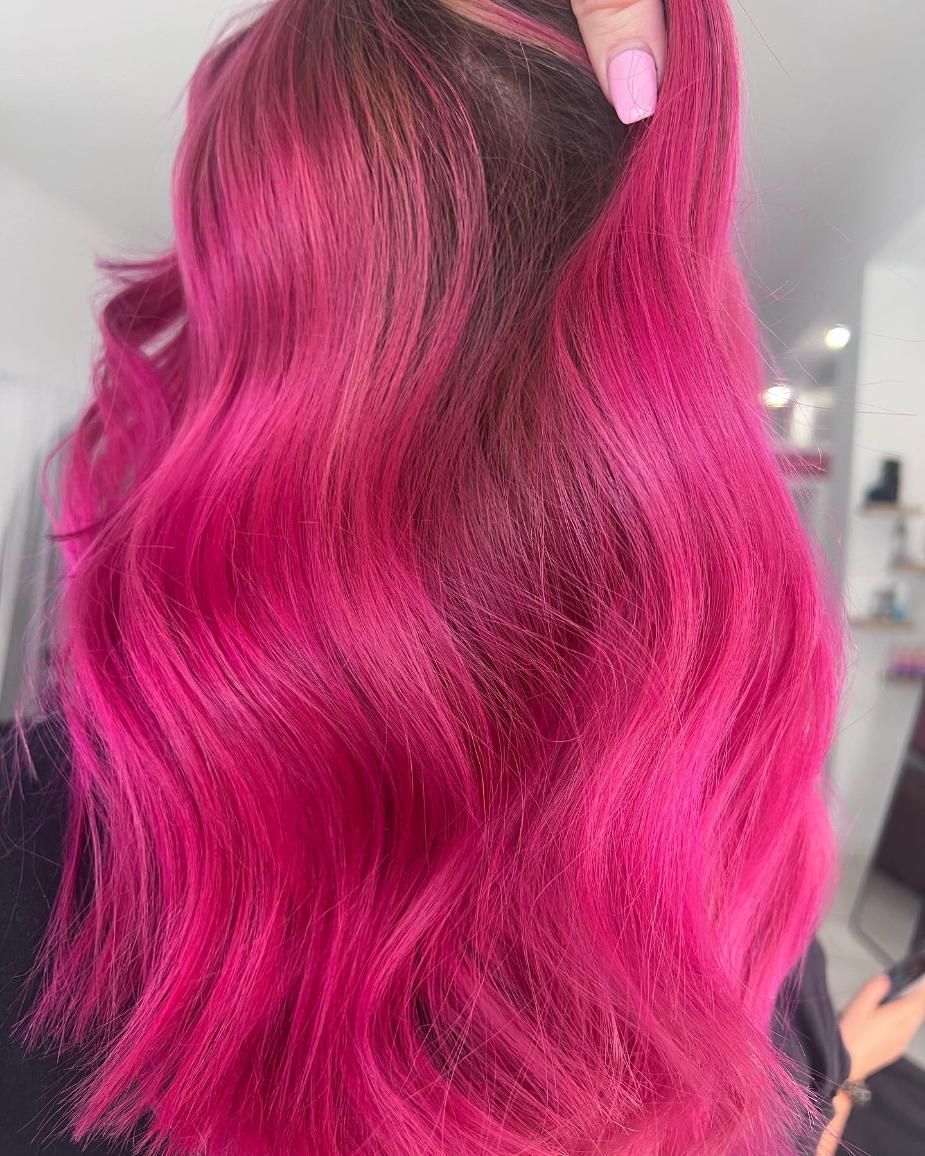 A Woman with Long Pink Hair Is Holding Her Hair in Her Hand — Losh Hair Lounge In Toowoomba City, QLD