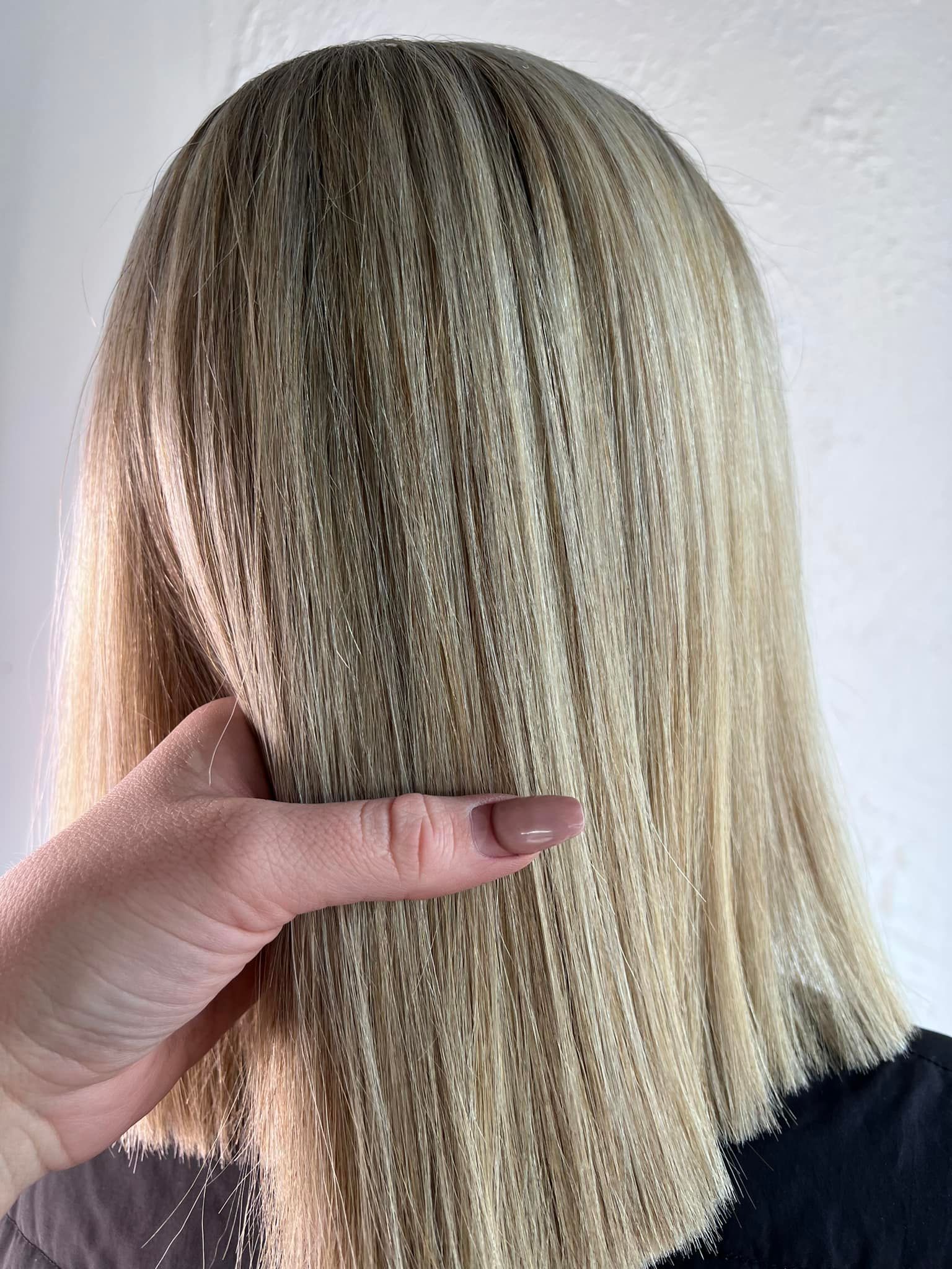 A Close up Of a Person 's Hand Touching a Woman 's Blonde Hair — Losh Hair Lounge In Toowoomba City, QLD